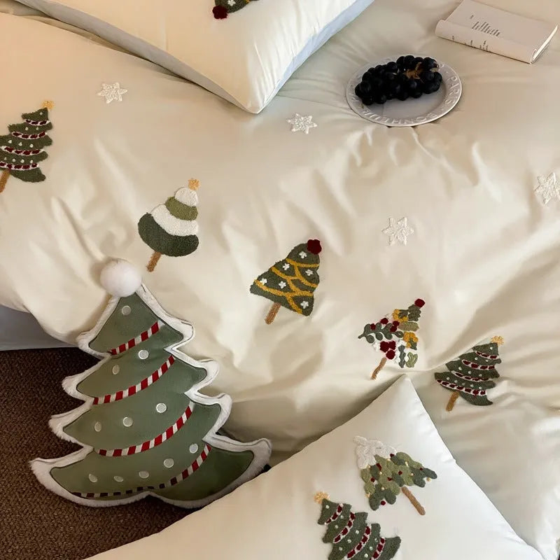 Cream blue cotton duvet cover and pillowcases with embroidered green Christmas tree and flower design.