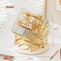 Clear and amber gold rotating plastic cosmetics storage box organiser on a vanity.