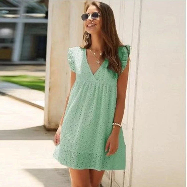 A stylish V-neck cotton dress with a flowy knee-length skirt, available in a variety of vibrant colors.