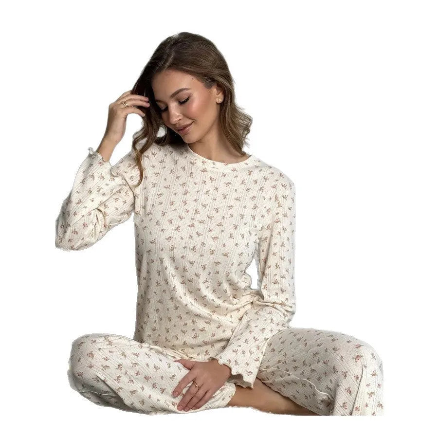 White women's floral print lounge suit with long bell sleeve top and wide leg trousers.