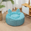 Blue faux fur plush enclosed cat bed house on a wooden floor