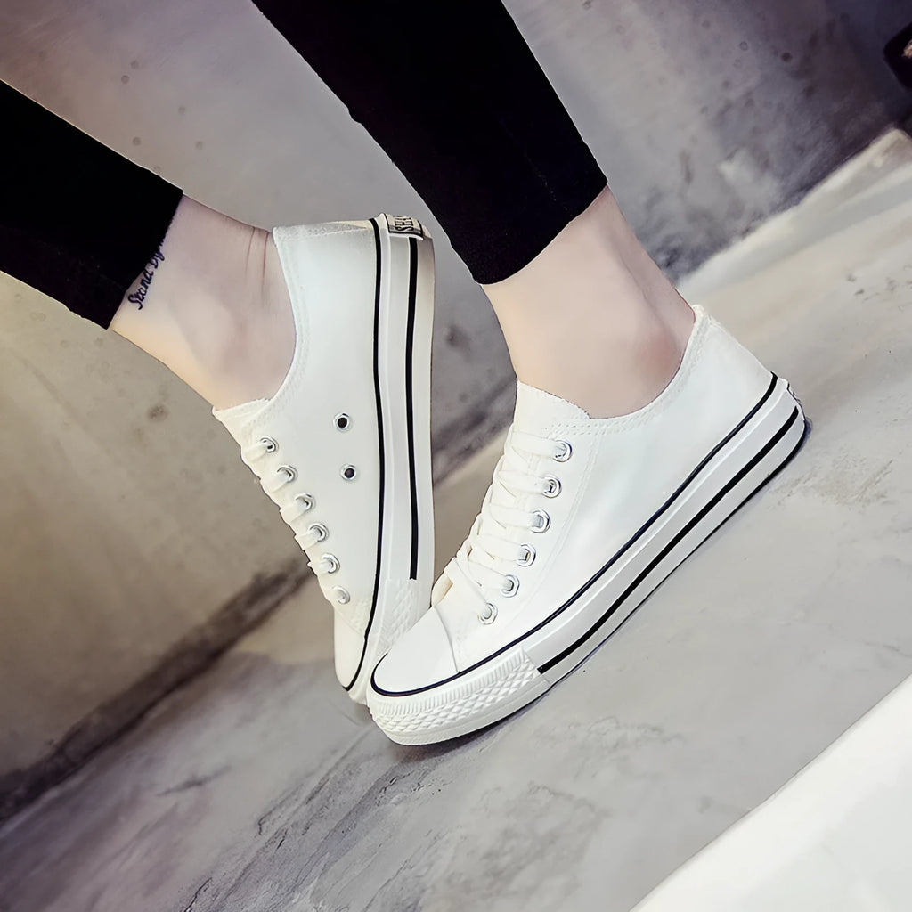 Women's solid colour casual canvas shoes shown in black, white black, white red, and all black options.