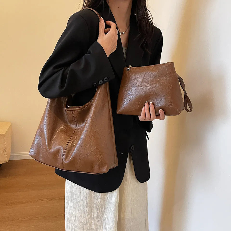 Women's large capacity PU shoulder tote bag in brown with sewing line detail and single strap
