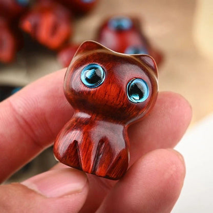 Handcrafted sandalwood kitten ornaments in various styles and colours