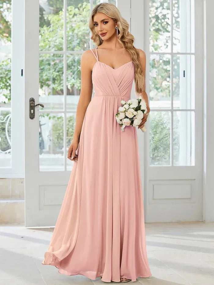 Long pleated A-line dress in light green with sleeveless sling neckline design.