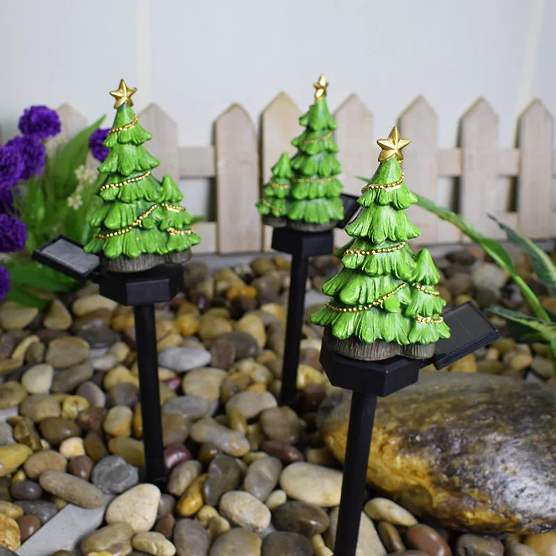 Solar Christmas tree ground plug light with warm white LED on a lawn, IP65 waterproof resin construction