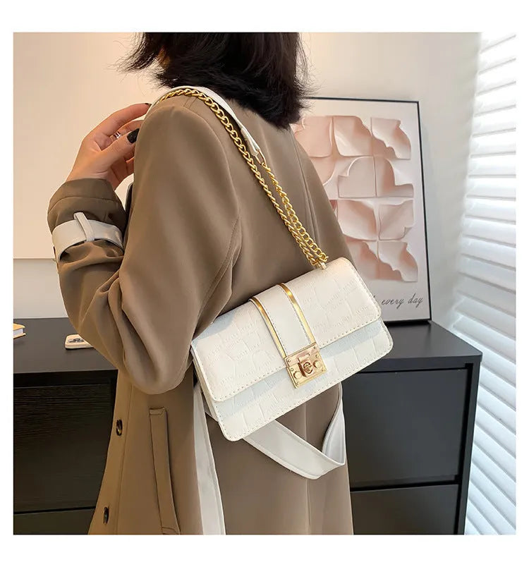 Horizontal square PU shoulder bag in khaki with contrast stitching and chain strap on a white background