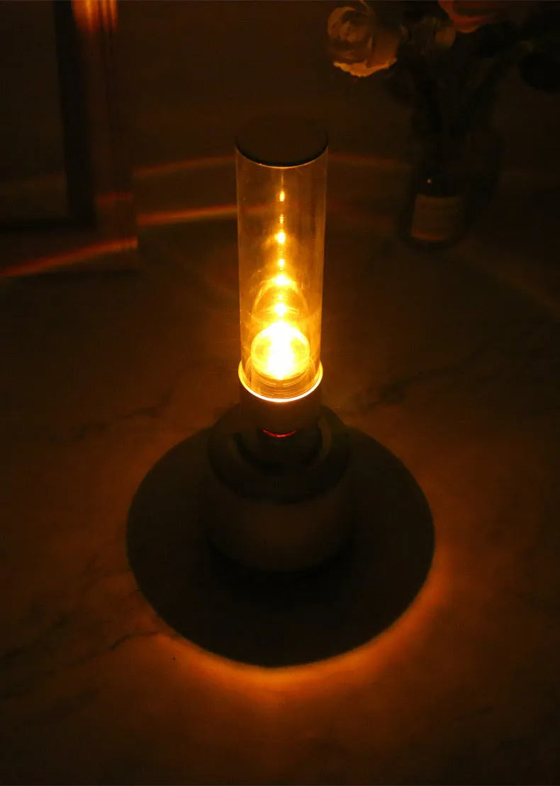 White silver cylindrical Bluetooth speaker and night light unit on a table.