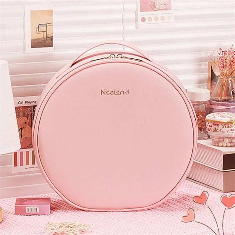 Round pink LED makeup bag open showing internal partitions and illuminated mirror.