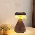 Small black USB rechargeable LED night lamp with electrodeless dimming on a wooden surface.