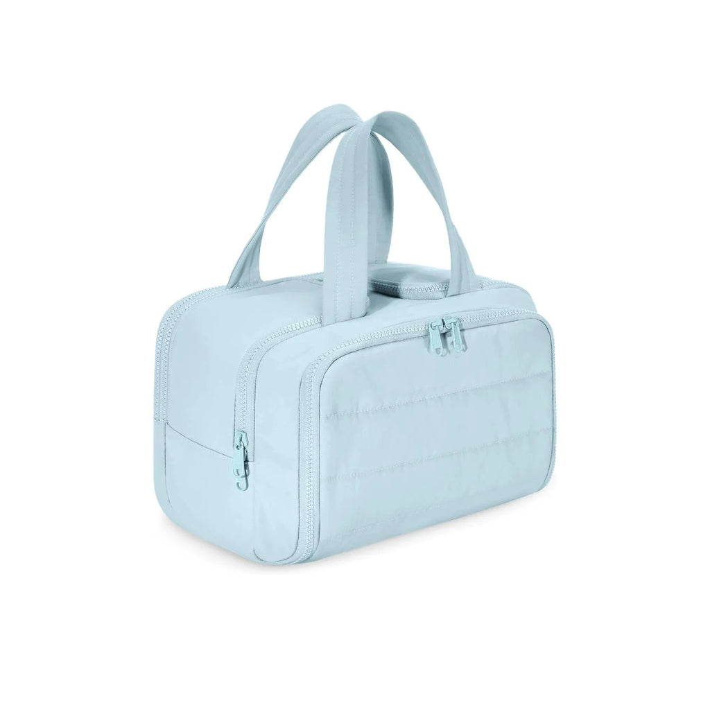 Large fluffy travel toiletry bag in creamy-white, shown wide open with dimensions 29.97 by 18.54 by 21.08 cm.
