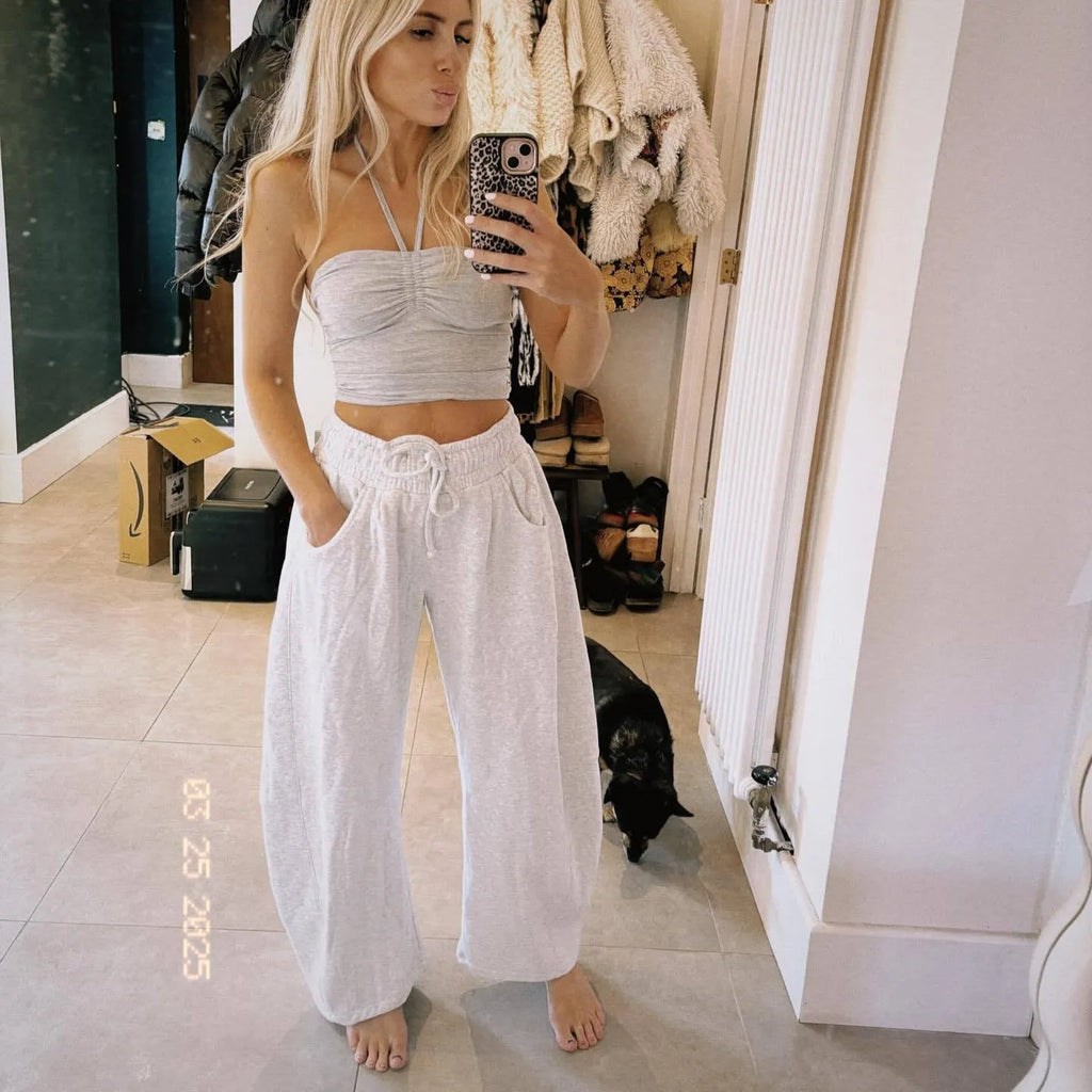 Loose cropped sports sweatpants with elastic waistband and drawstring pockets in street fashion style