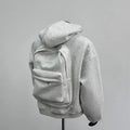 Men's grey hooded jacket with schoolbag-style back design showing front and back views