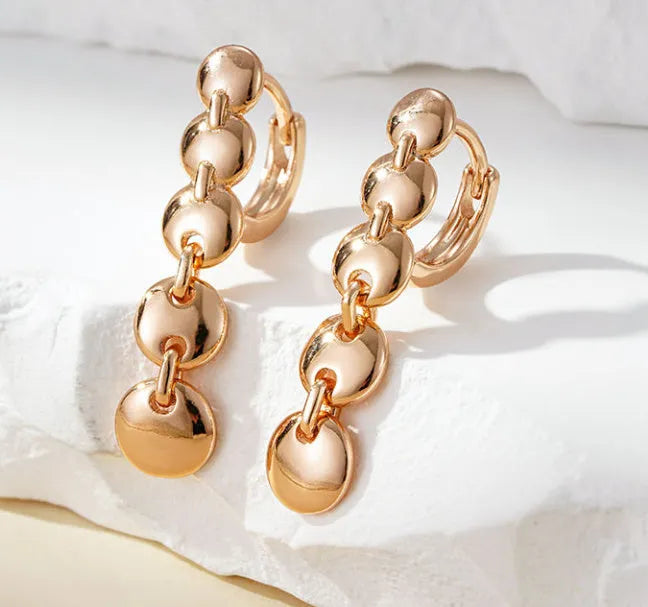 Gold tone retro long circle earrings with woven texture on a copper base.