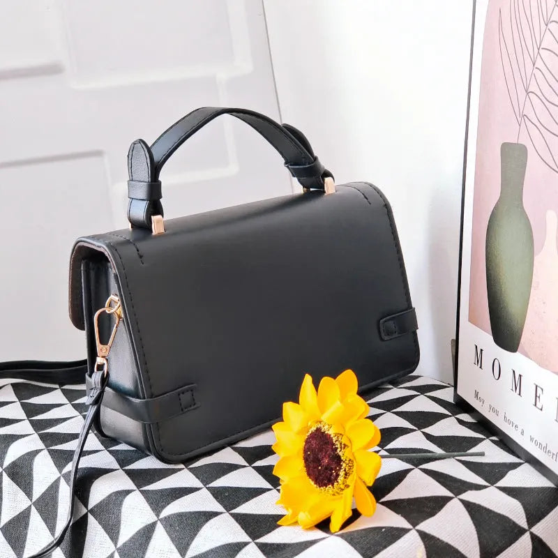 Small square retro patterned crossbody bag in PU leather with a file compartment inside.