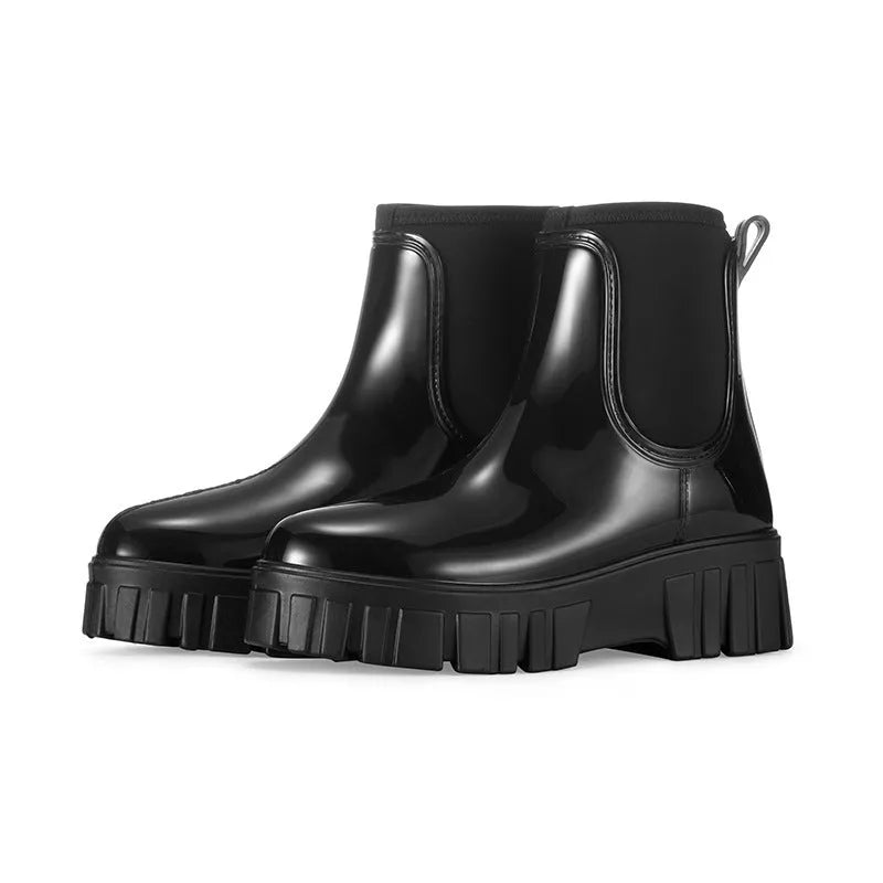 PVC low tube rain boot in solid colour with flat heel and non-slip sole.