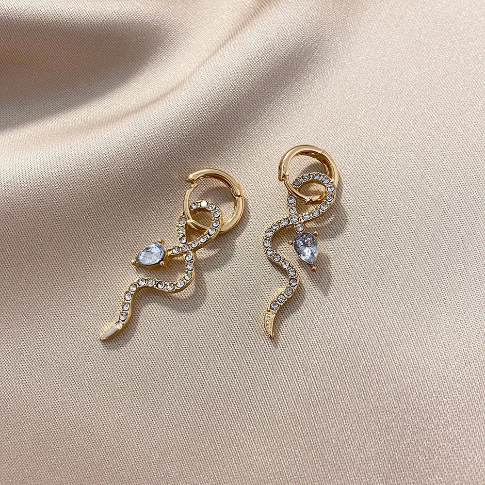 Elegant snake-shaped dangle earrings with a golden hue, showcasing a blend of European and American style