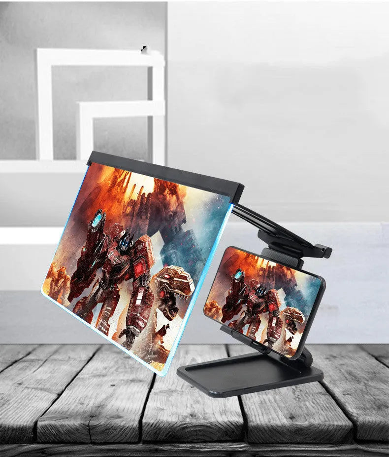 Black folding mobile phone screen magnifier and detachable holder on a desktop.