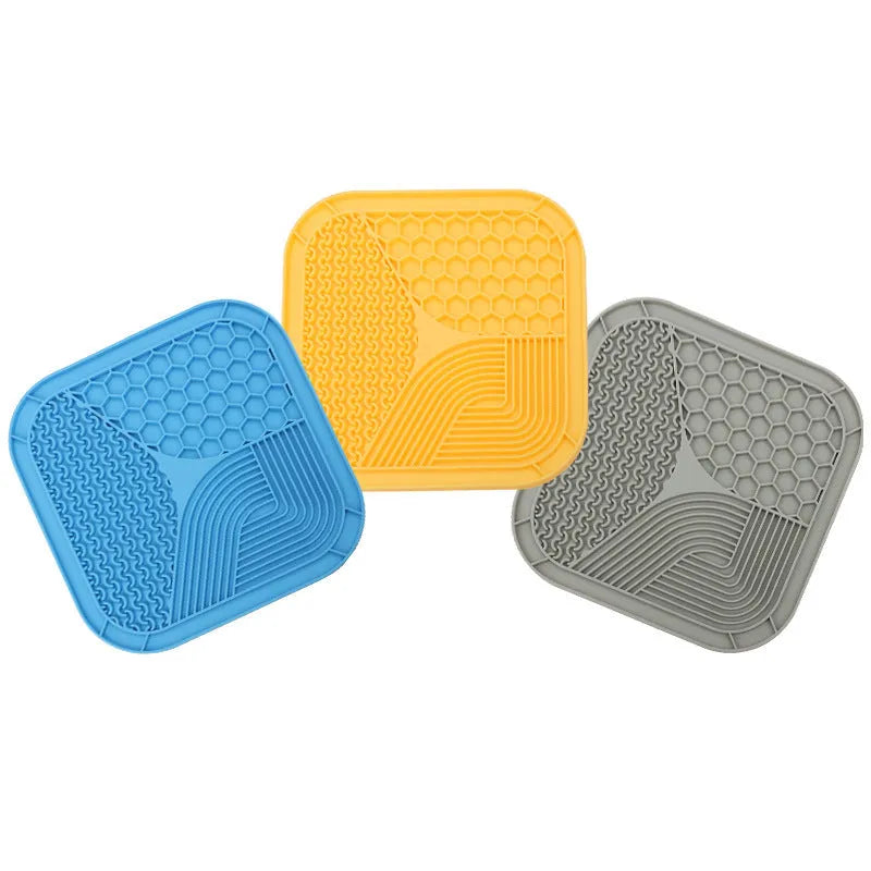 Gray silicone anti-choke slow feeding dog licking pad with textured surface on a flat surface