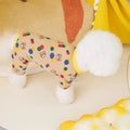 Beige dog costume with colourful ball bear design, made from cotton and spandex blend.