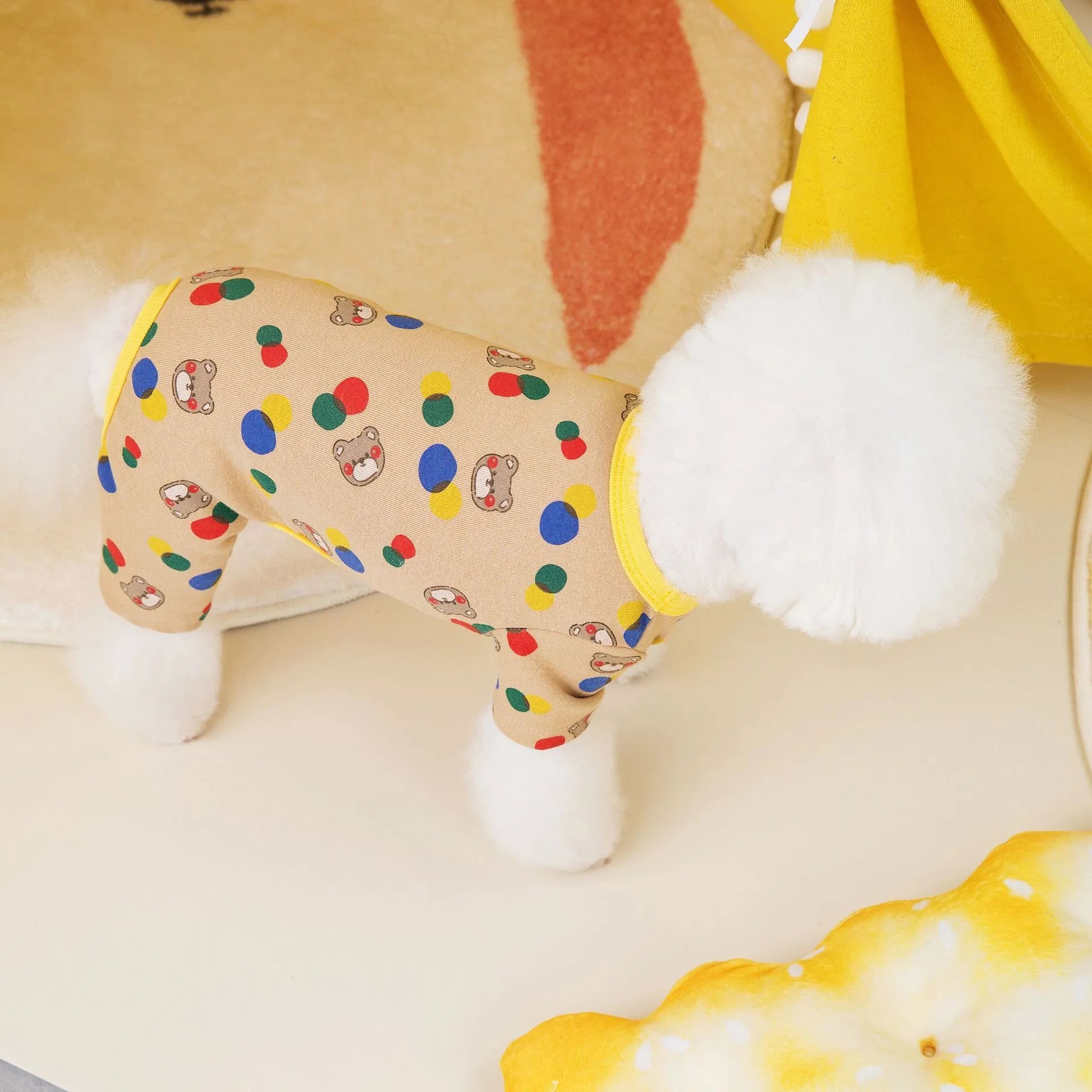 Beige dog costume with colourful ball bear design, made from cotton and spandex blend.