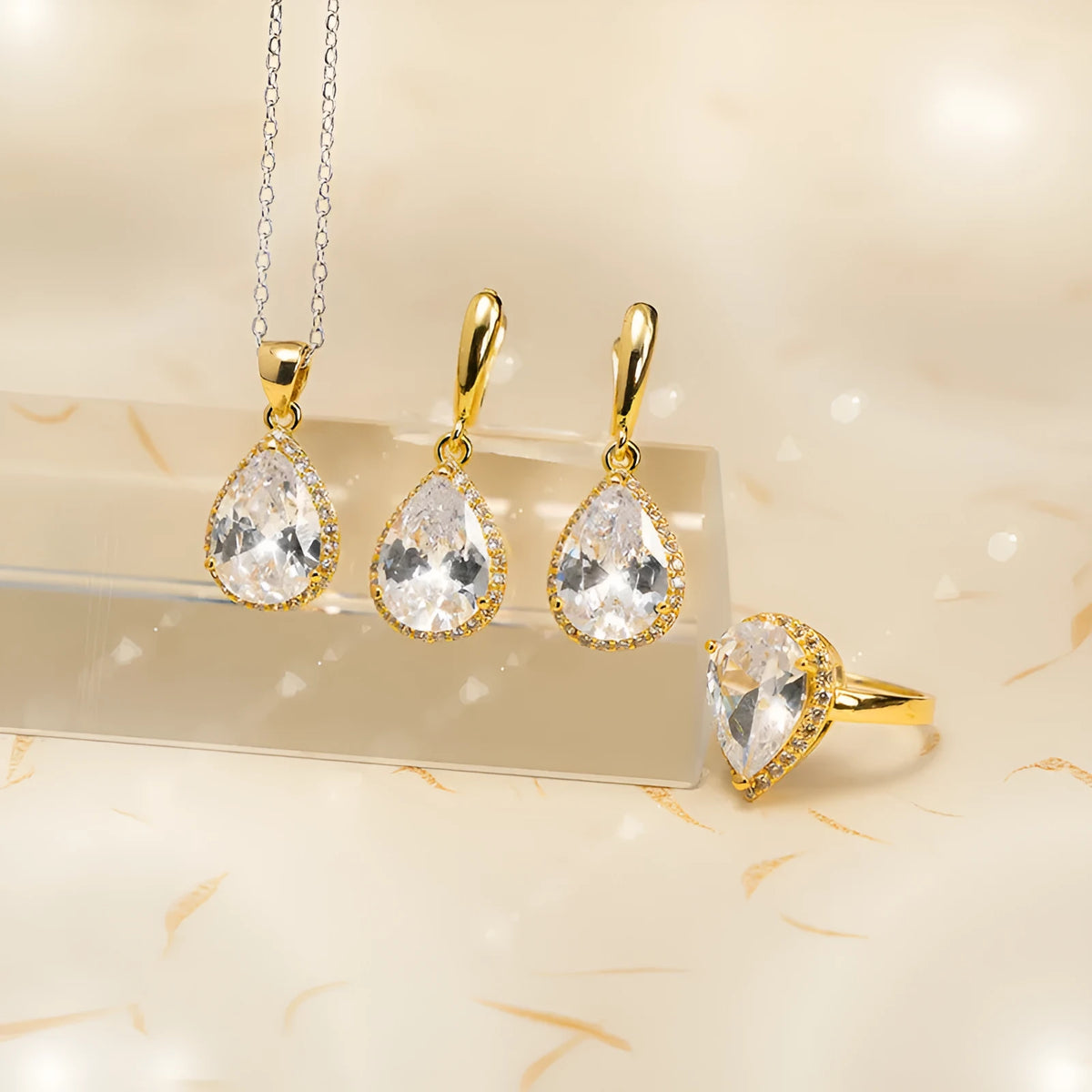 Drop-shaped zircon non-fading three-piece jewellery set gold plated with mixed gem inlaid pendant in emerald gold colour on white background