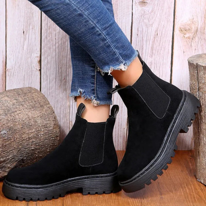 Women's Martin boots in solid colour with chunky platform sole, flat heel, and leather stitching