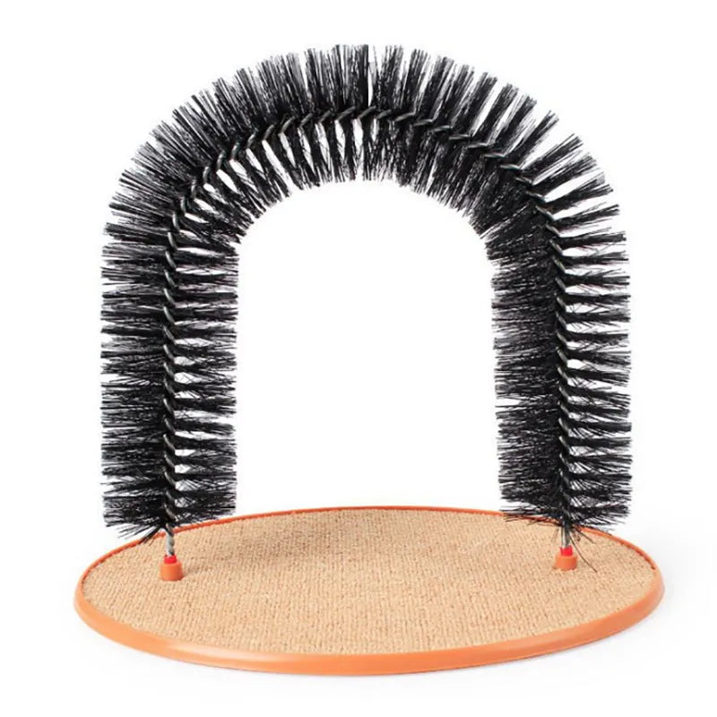 White plastic cat grooming arch scratcher toy with built-in brush bristles on a wooden floor.