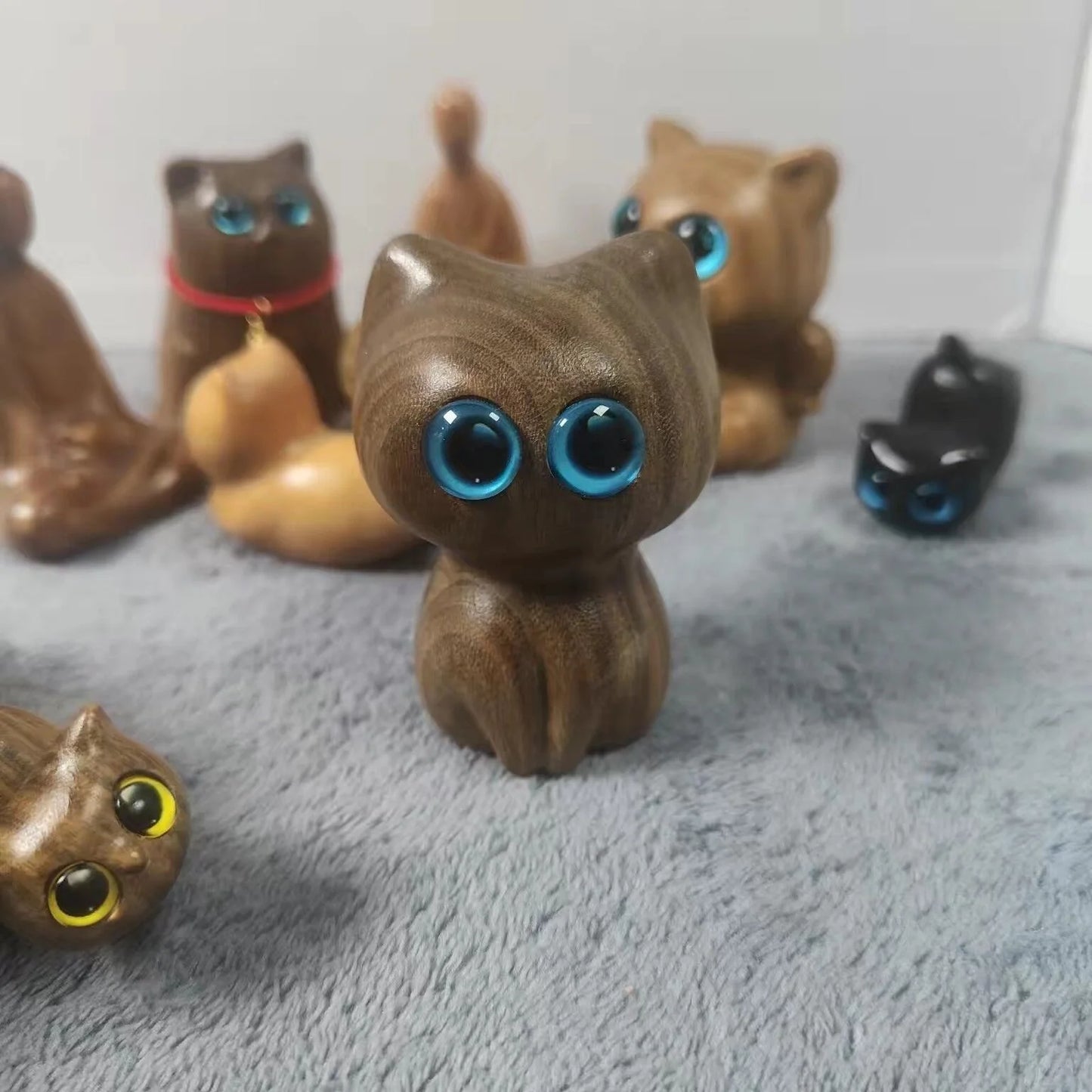 Handcrafted sandalwood kitten ornaments in various styles and colours