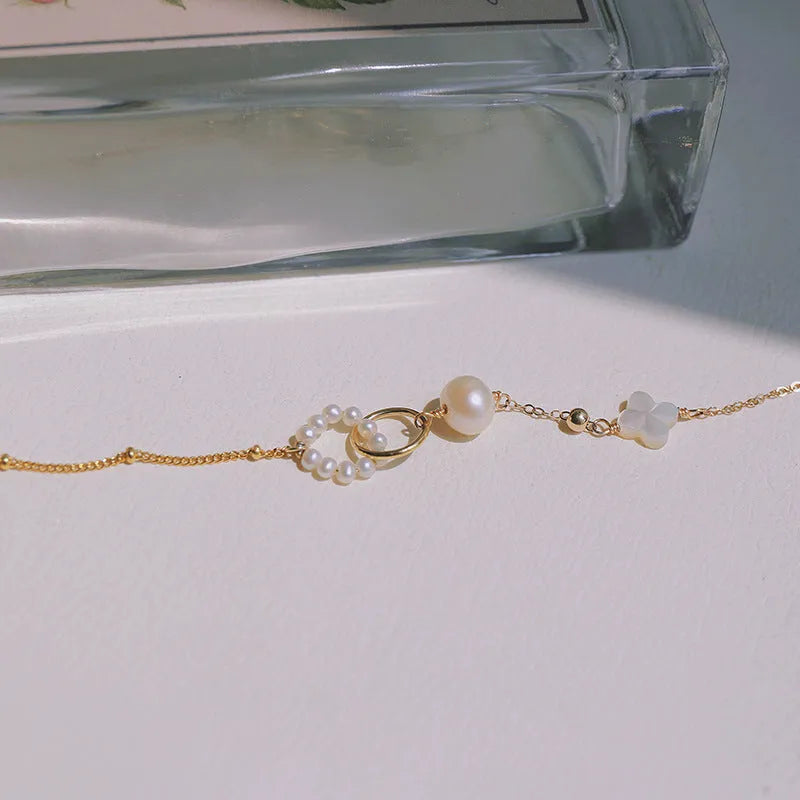Women's natural pearl bracelet with gold-plated metal setting.