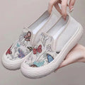 Women's canvas slip-on shoes with plastic soles in black and white colours showing sewing thread decoration