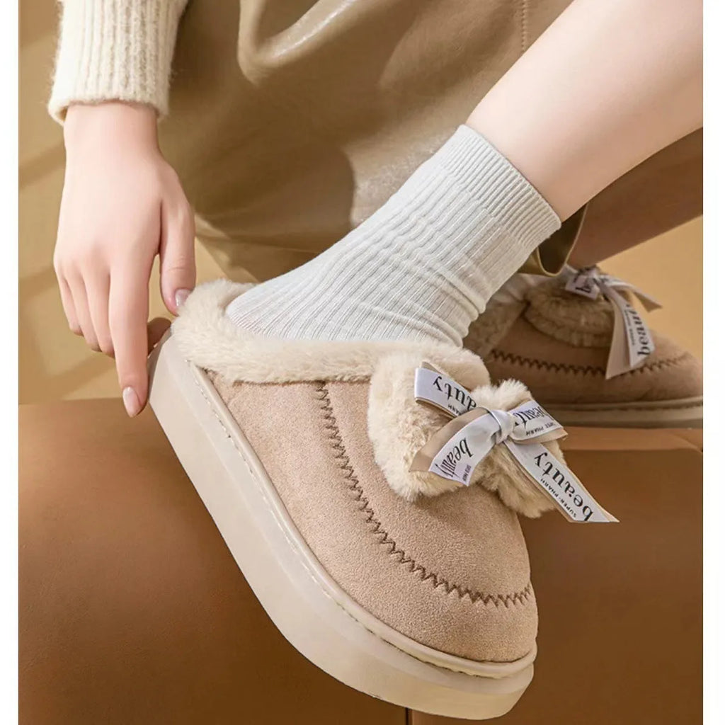 Beige women's ribbon bow half slipper with suede upper and thick sole on a neutral background