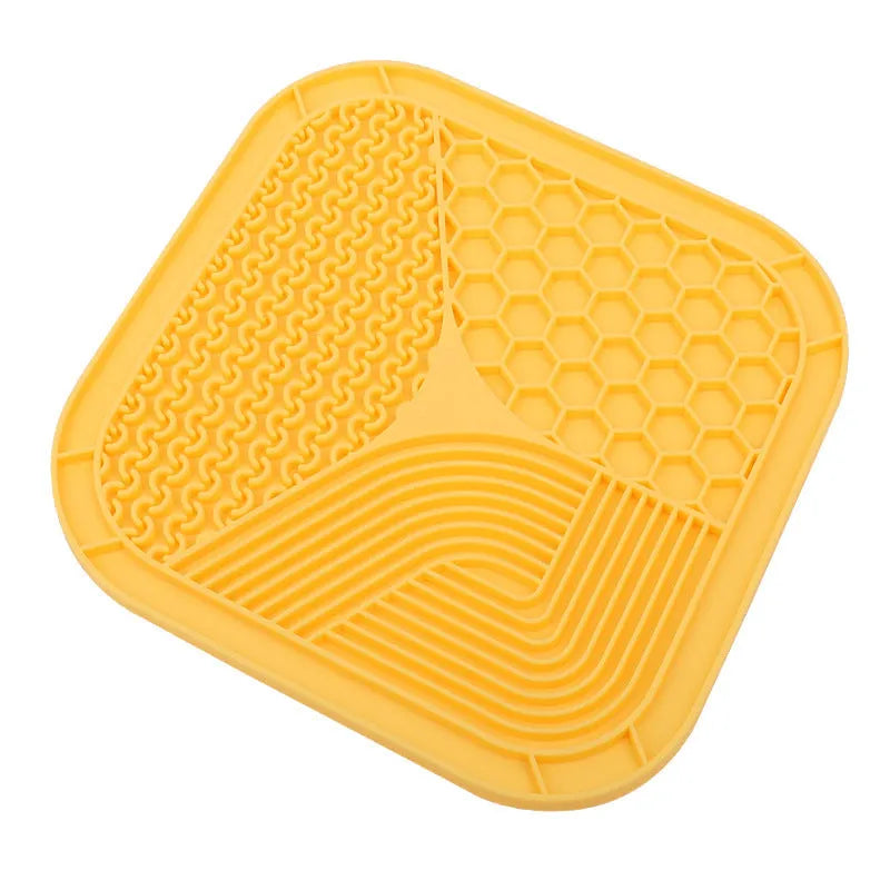Gray silicone anti-choke slow feeding dog licking pad with textured surface on a flat surface