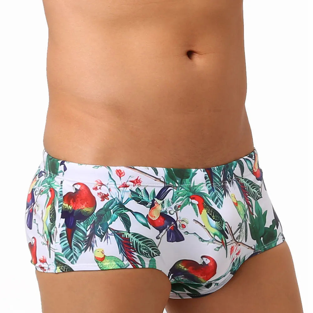 Men's floral bird print swim trunks with cup compartment in blue and white design