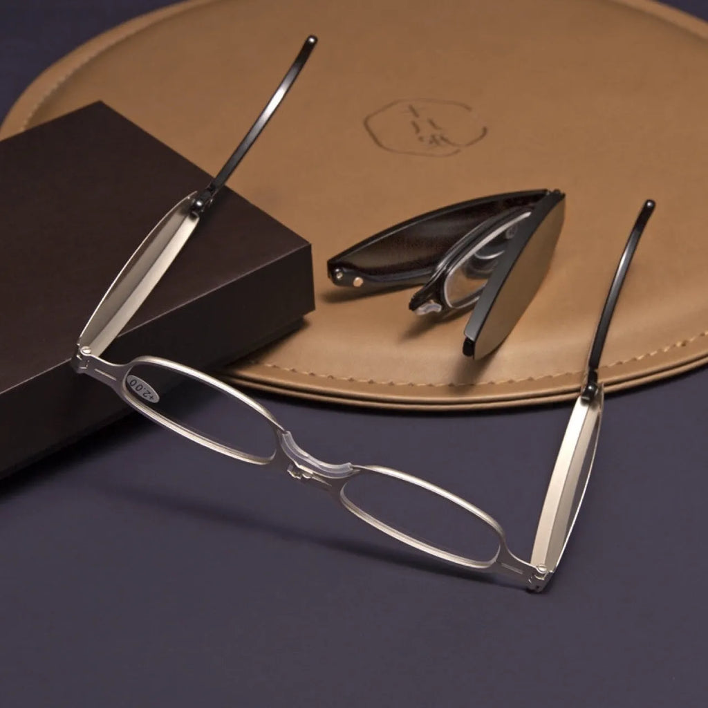 Black folding presbyopic glasses with retro frame and ring detailing, shown in open and closed positions