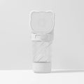 Green, pink, or white 3-in-1 portable pet water bottle with food container and garbage bag dispenser and shoulder strap.