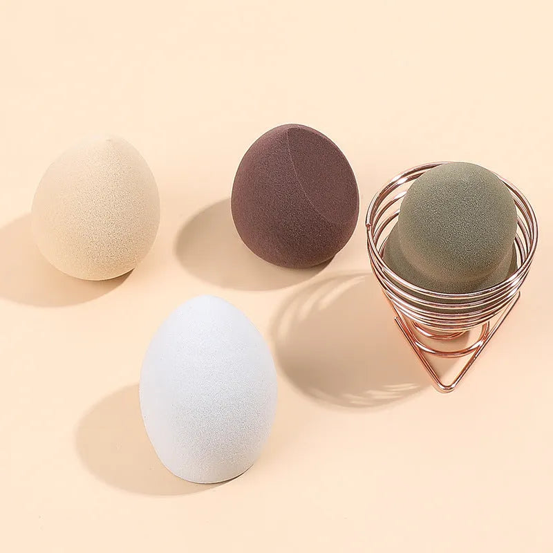Four Hydrophilic Polyurethane beauty eggs in assorted colours on a metal stand, size 6x4cm each