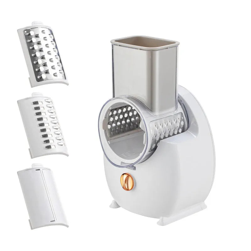 White electric vegetable slicer with rotary grater, feeding port, and three cutting blade pairs on kitchen counter