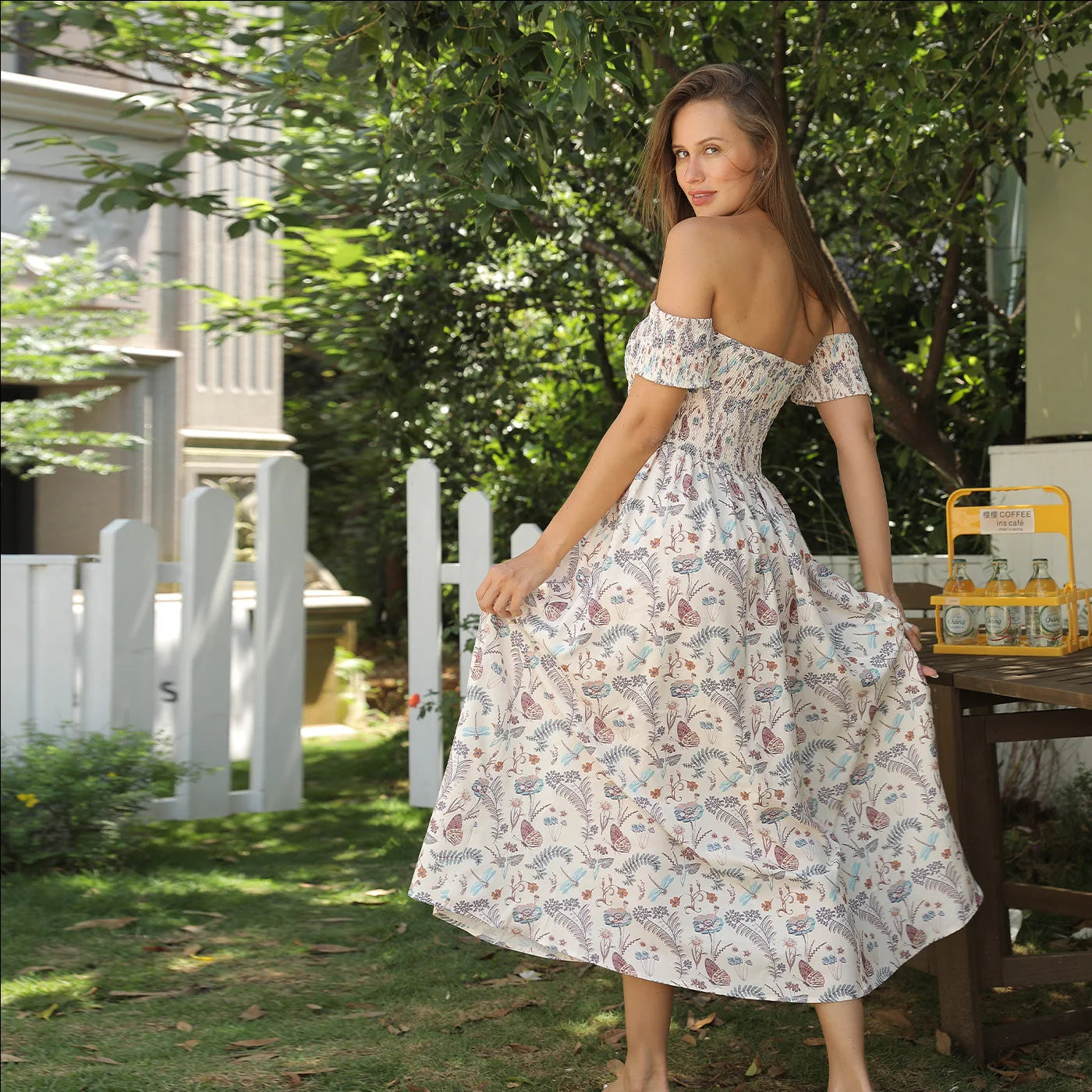 Women's off-shoulder strapless floral dress in a vibrant pattern, perfect for summer outings.