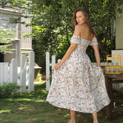 Women's off-shoulder strapless floral dress in a vibrant pattern, perfect for summer outings.