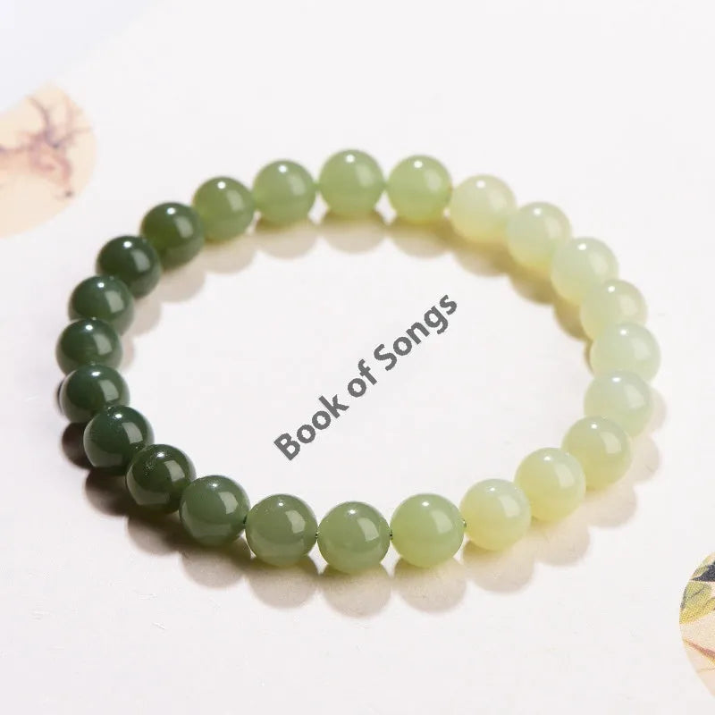 Natural Hetian jade bracelet with gradient water colour round beads on a wrist