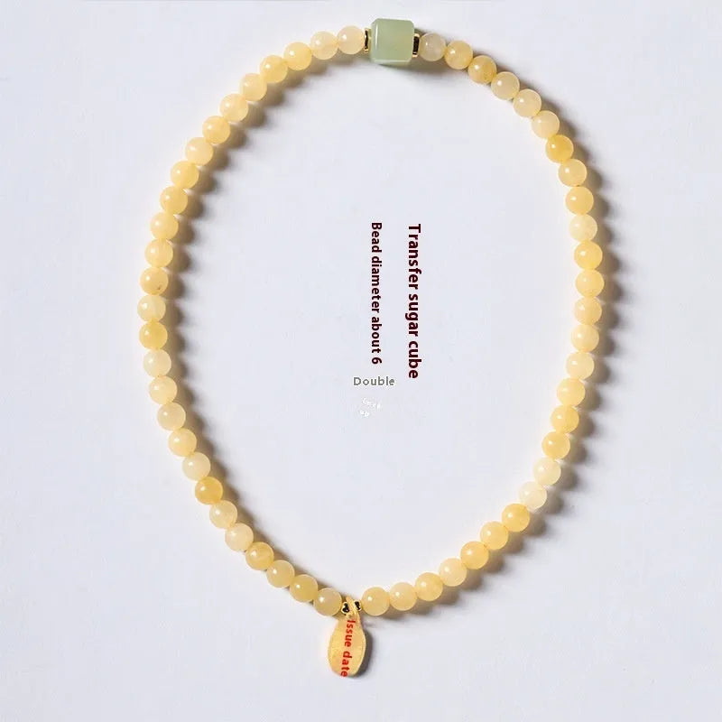 Topaz-coloured women's bracelet with six-word mantra barrel beads and sugar jade cubes in hand-woven design