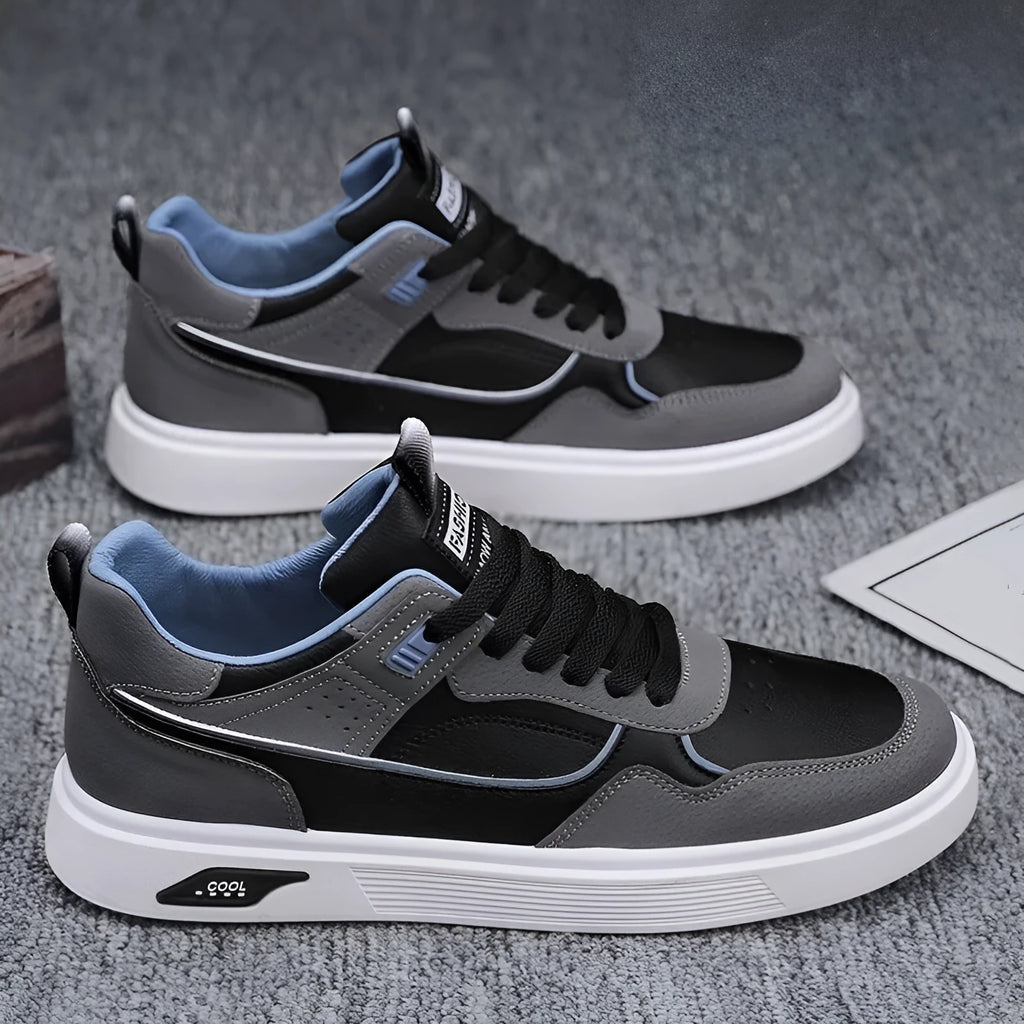 Men's low-top canvas sneakers in black with mesh lining and leather stitching detail.
