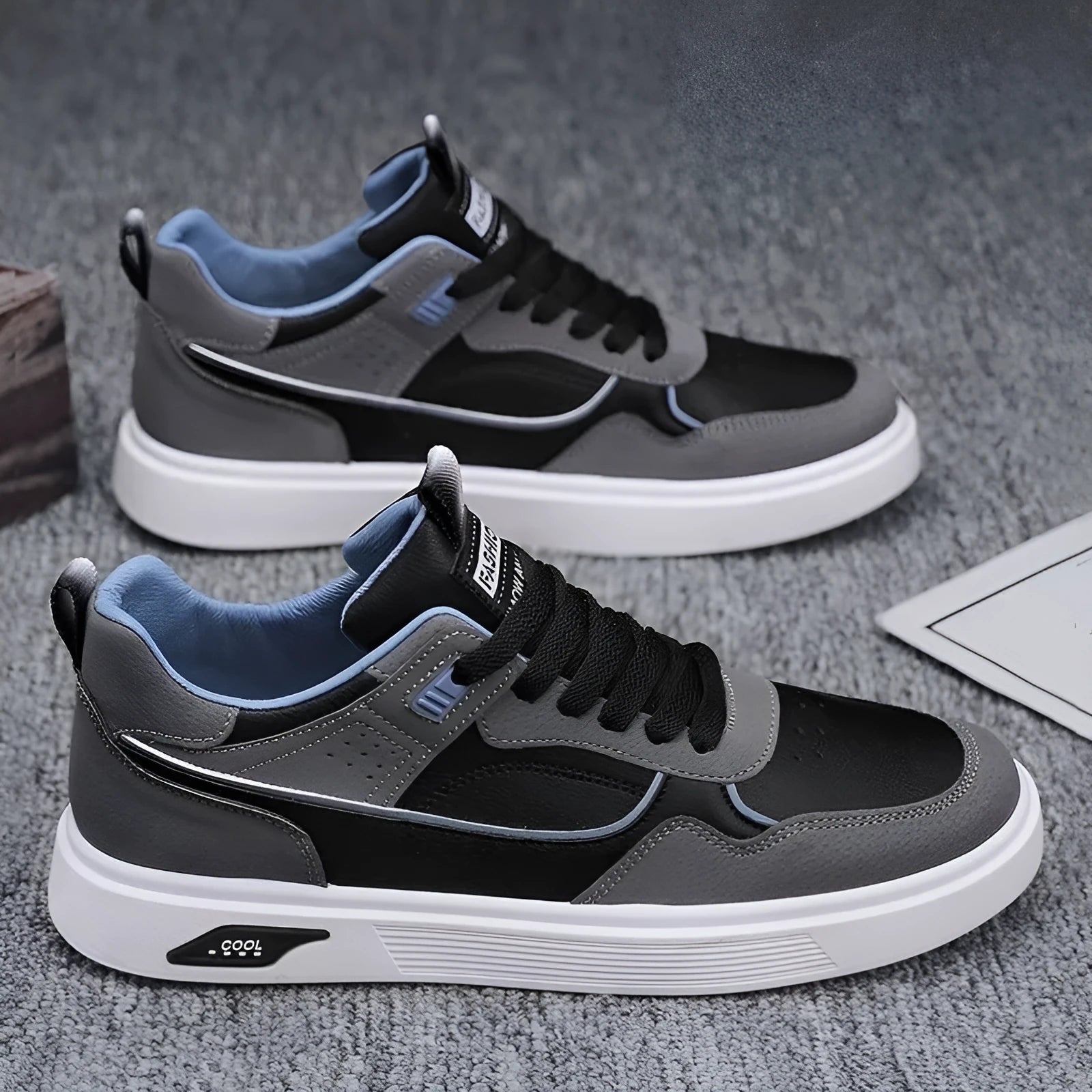 Men's low-top canvas sneakers in black with mesh lining and leather stitching detail.