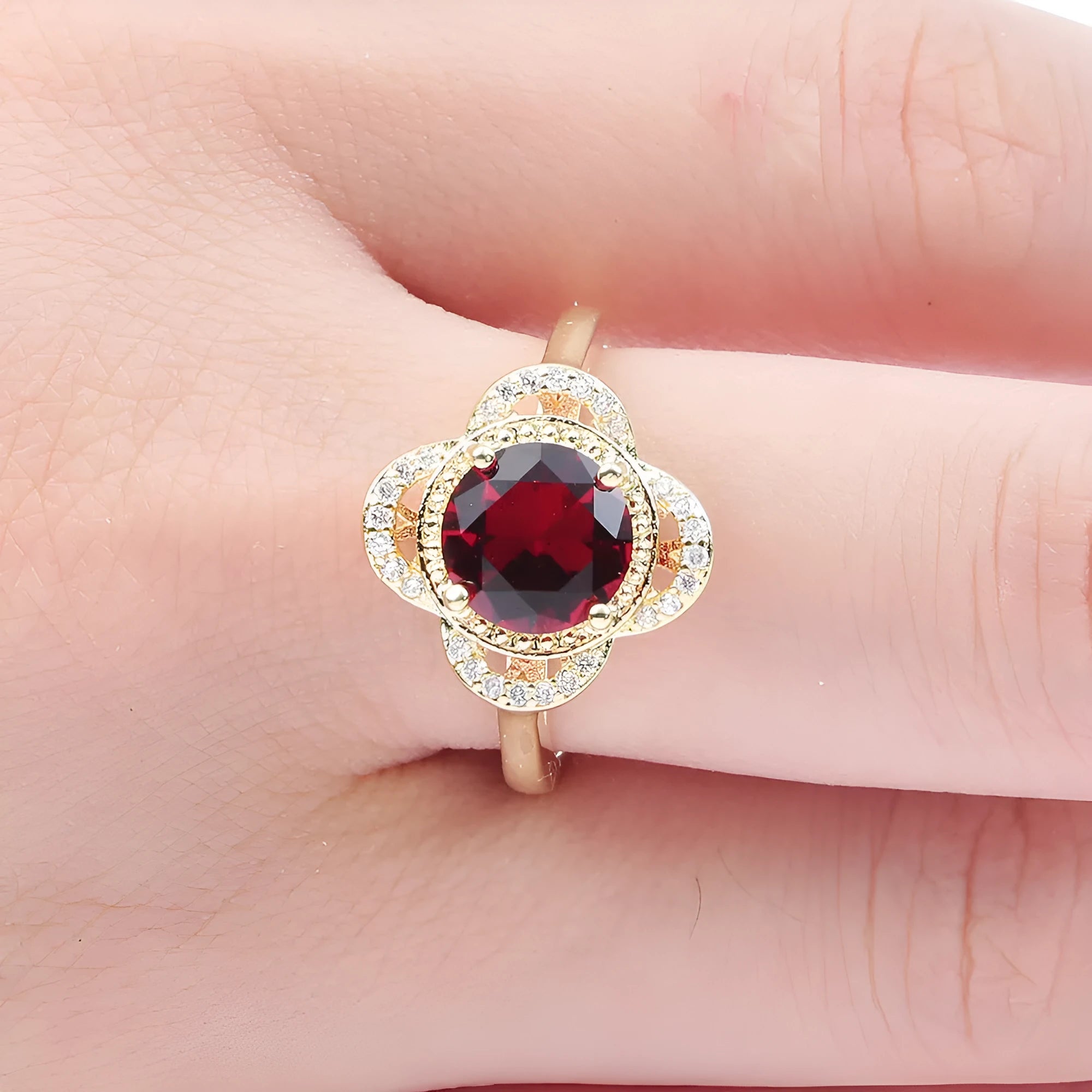 Copper ring with a fruit-shaped zircon stone inlay on a finger.