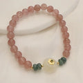 Women's strawberry quartz bracelet with blue water emerald stones and round jade pendant on geometric chain
