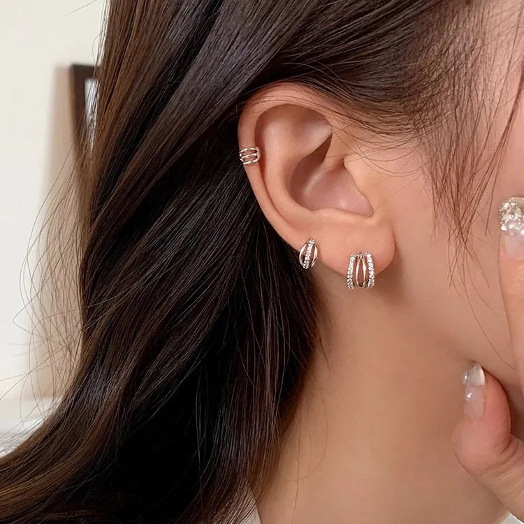 A pair of geometric-style earrings made from 925 silver with an electroplated finish, shown in large, medium, and small size options.