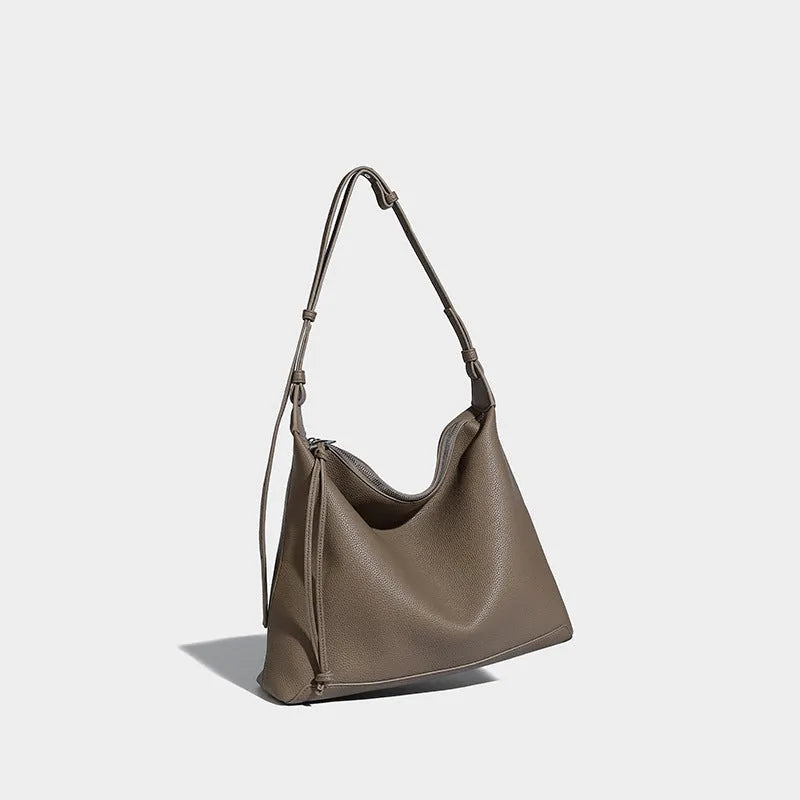 Large soft PU messenger bag in caramel colour showing shoulder strap and dimensions