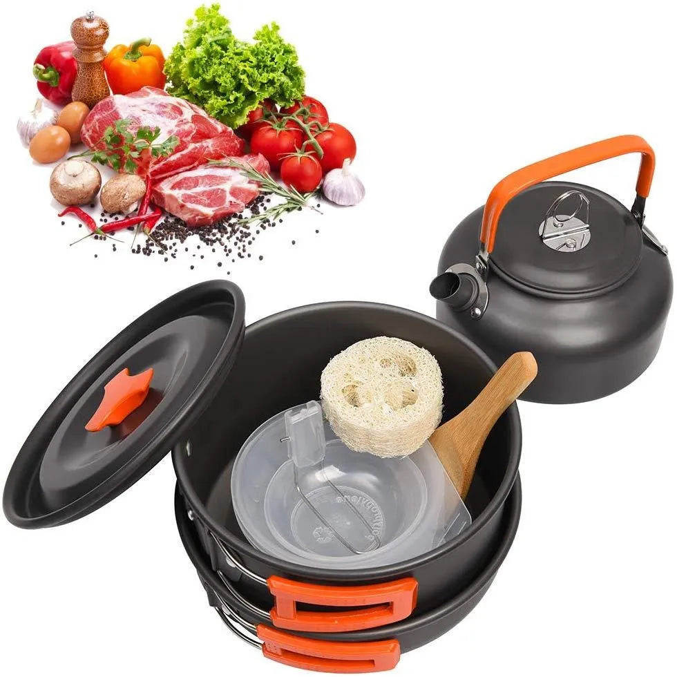 Orange folding camping cookware set with pots, pan, spoons, bowls in mesh bag on outdoor table