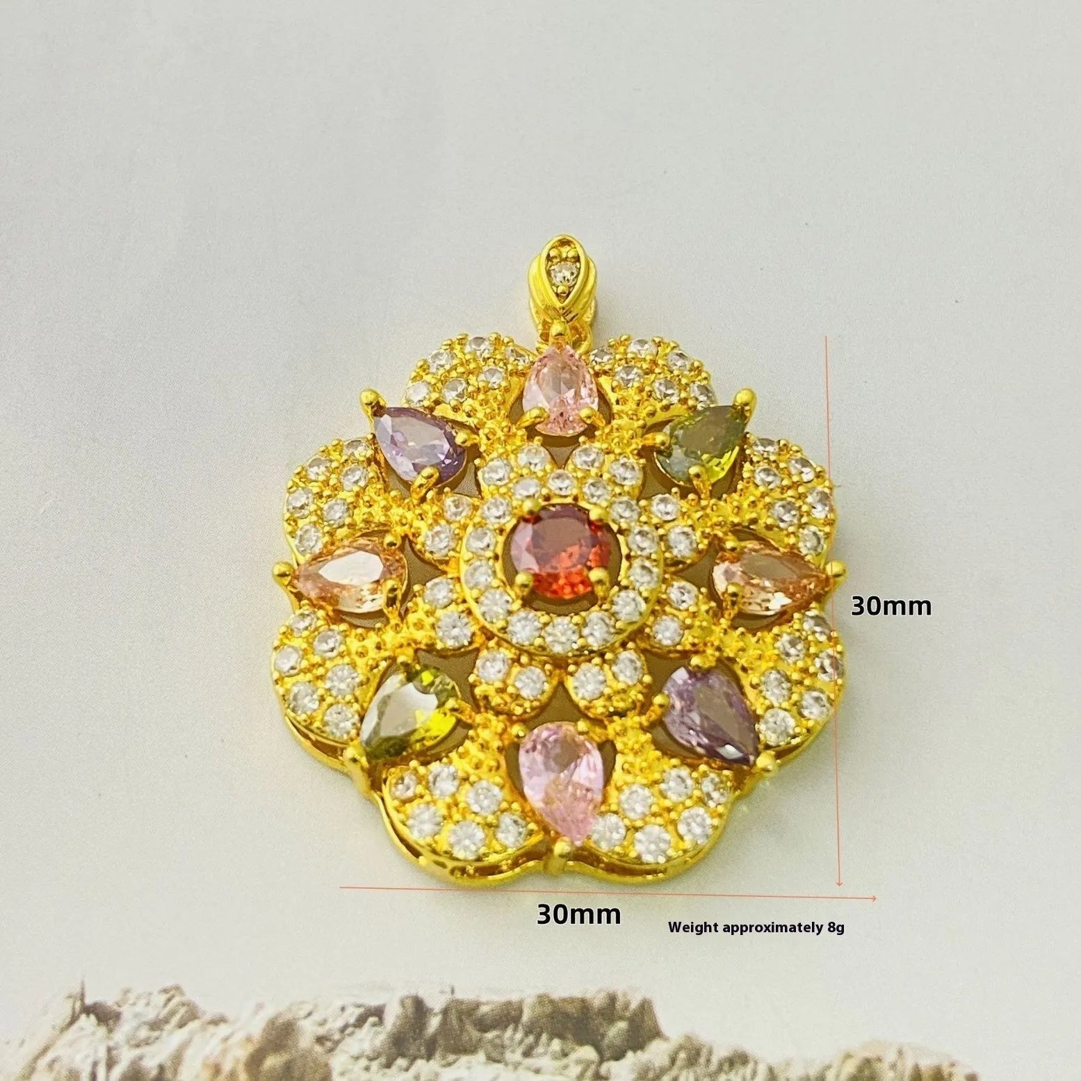 Close-up of a women's flower-shaped zircon pendant necklace in a gold tone on a model.